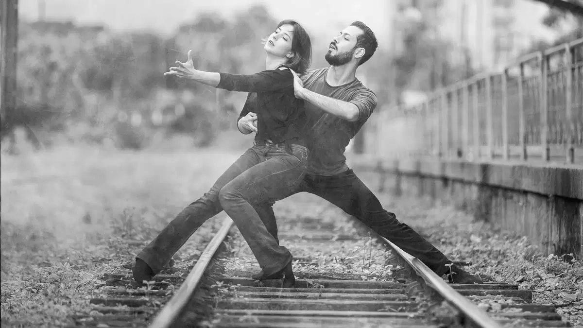 Casal em movimento expressivo representando o Jazz Dance
